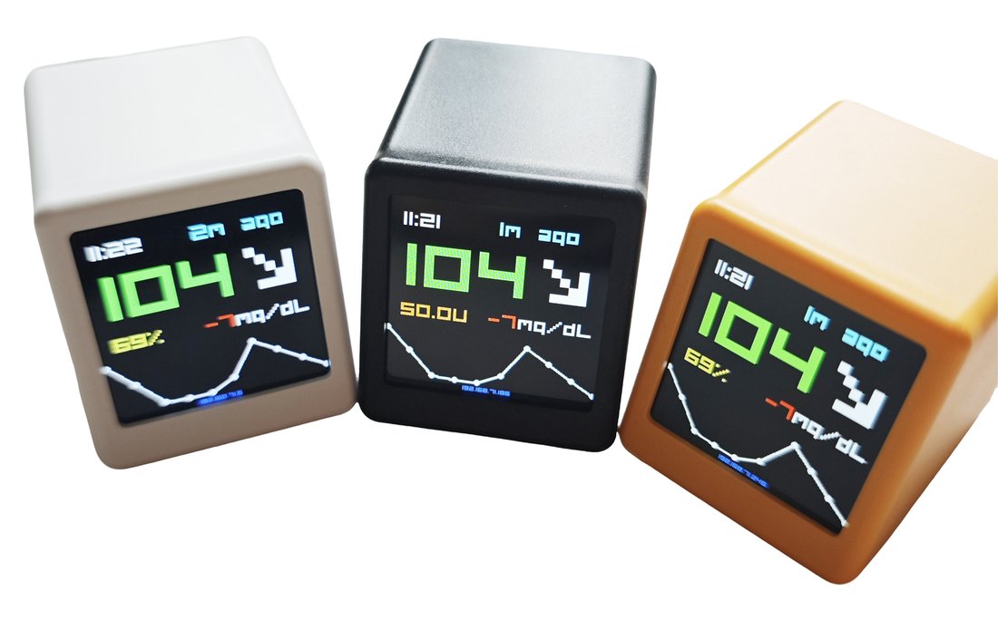 BGMate mini in white, graphite and amber, all displaying 104 mg/dL